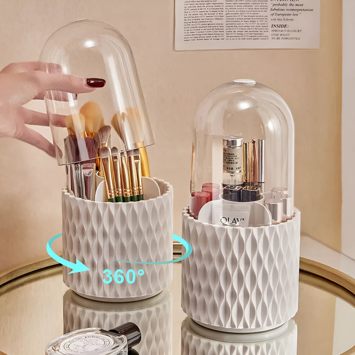 White rotating acrylic makeup brush holder with transparent dustproof lid on a desktop.