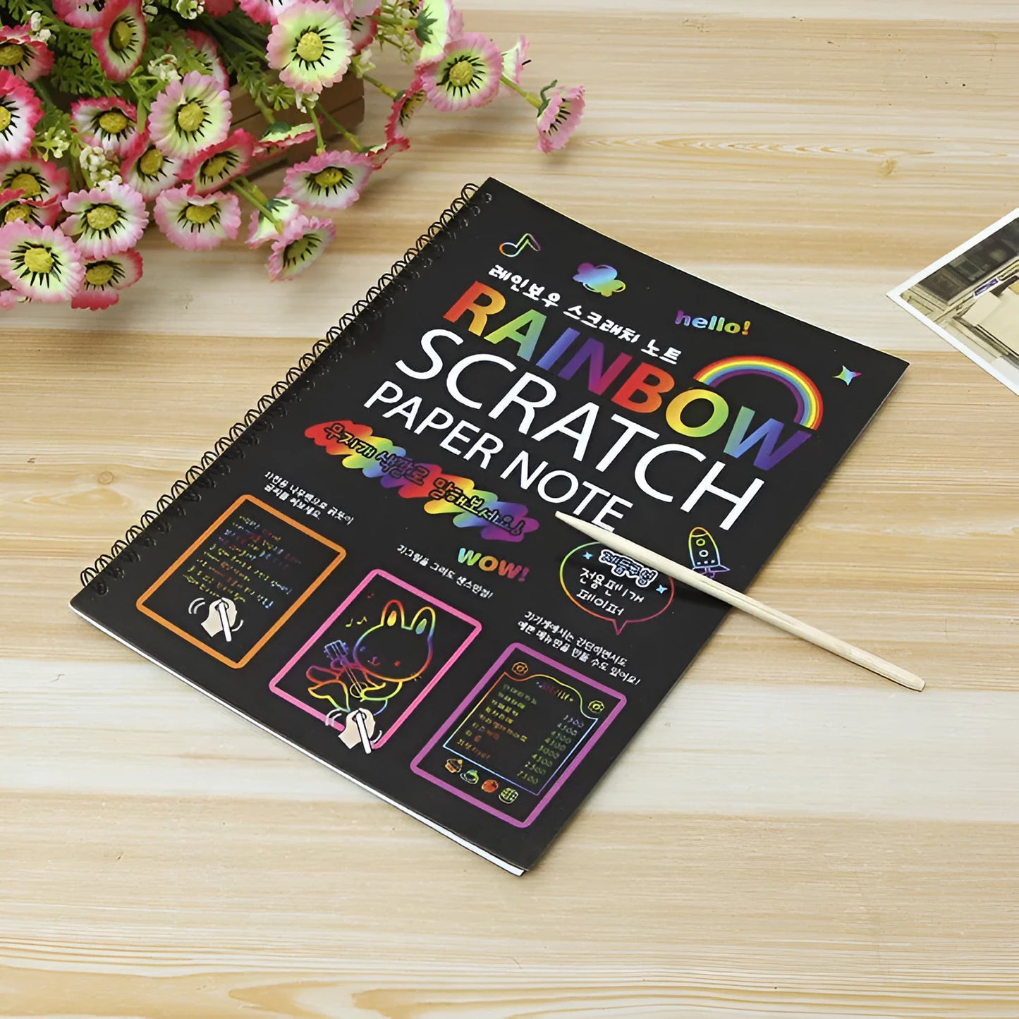 Children's large scratch art paper showing colourful patterns revealed through scraping