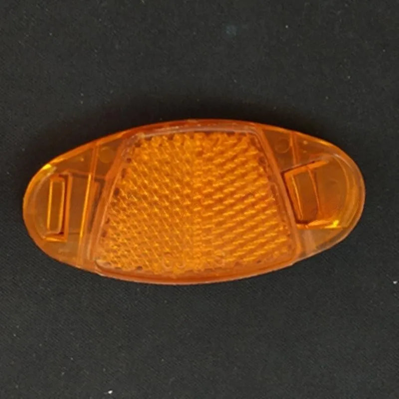 White and yellow plastic bicycle reflector for spoke mounting measuring 7.2 by 3.5 centimetres