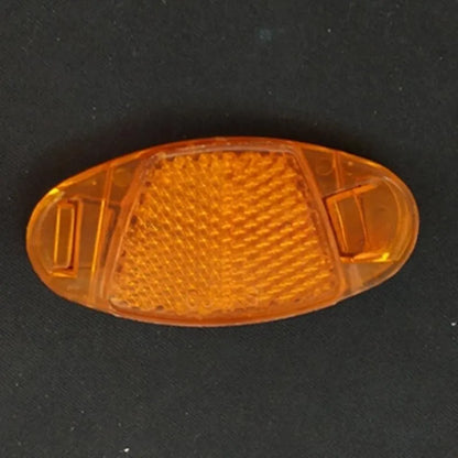 White and yellow plastic bicycle reflector for spoke mounting measuring 7.2 by 3.5 centimetres