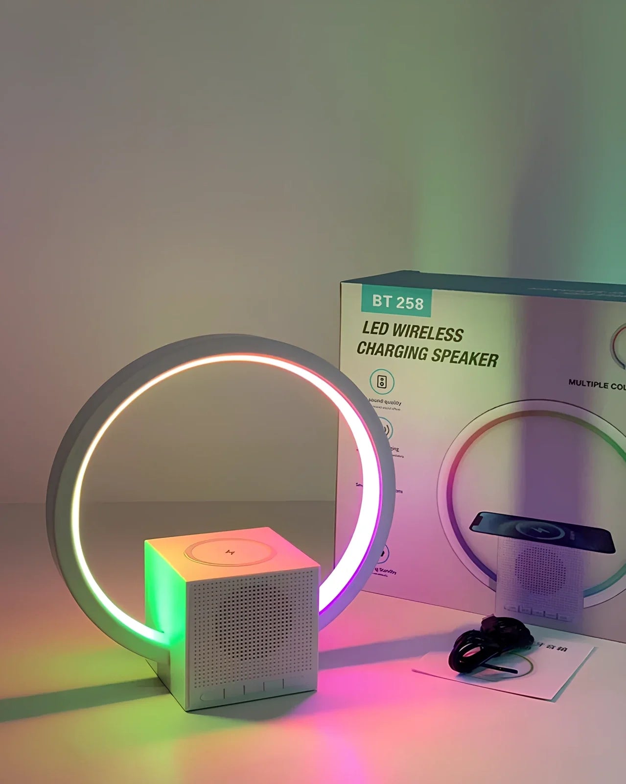 White smart speaker with wireless charging surface, LED lights, and Bluetooth connectivity