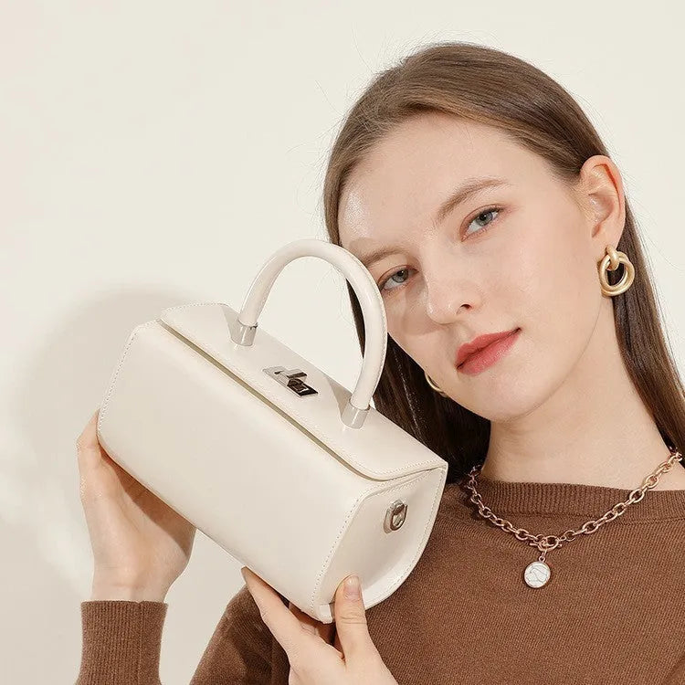 Leather one-shoulder crossbody women's bag in cowhide with box-type clamshell design, available in black, brown, milky white, and red colours for daily urban use