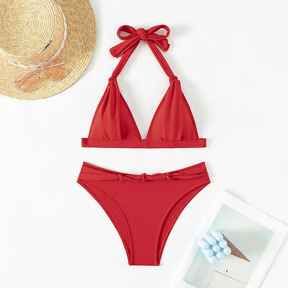 Red women's lace-up halterneck bikini top and shorts set on a mannequin