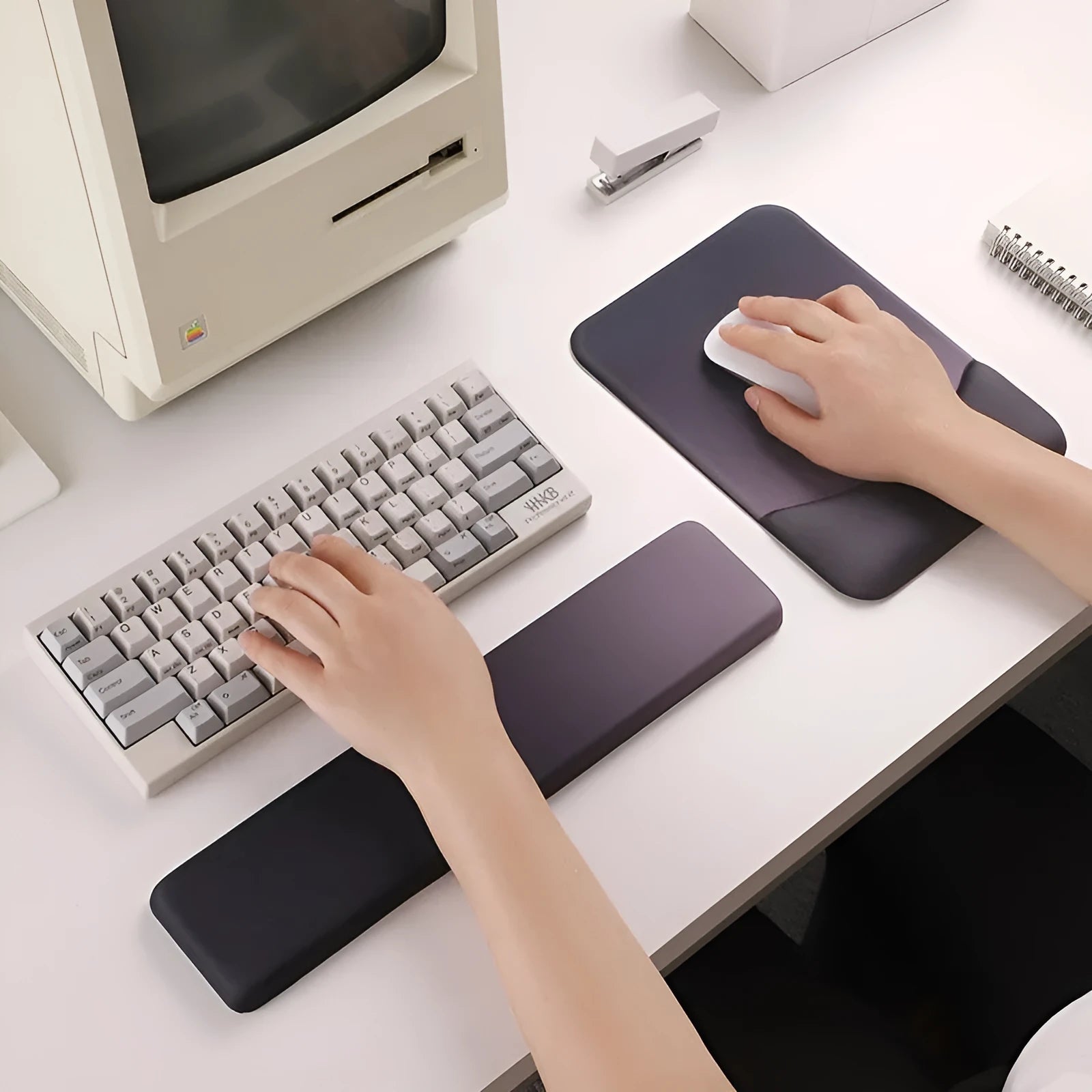 Square cloth-covered silica gel wrist rest mouse pad on a desk.