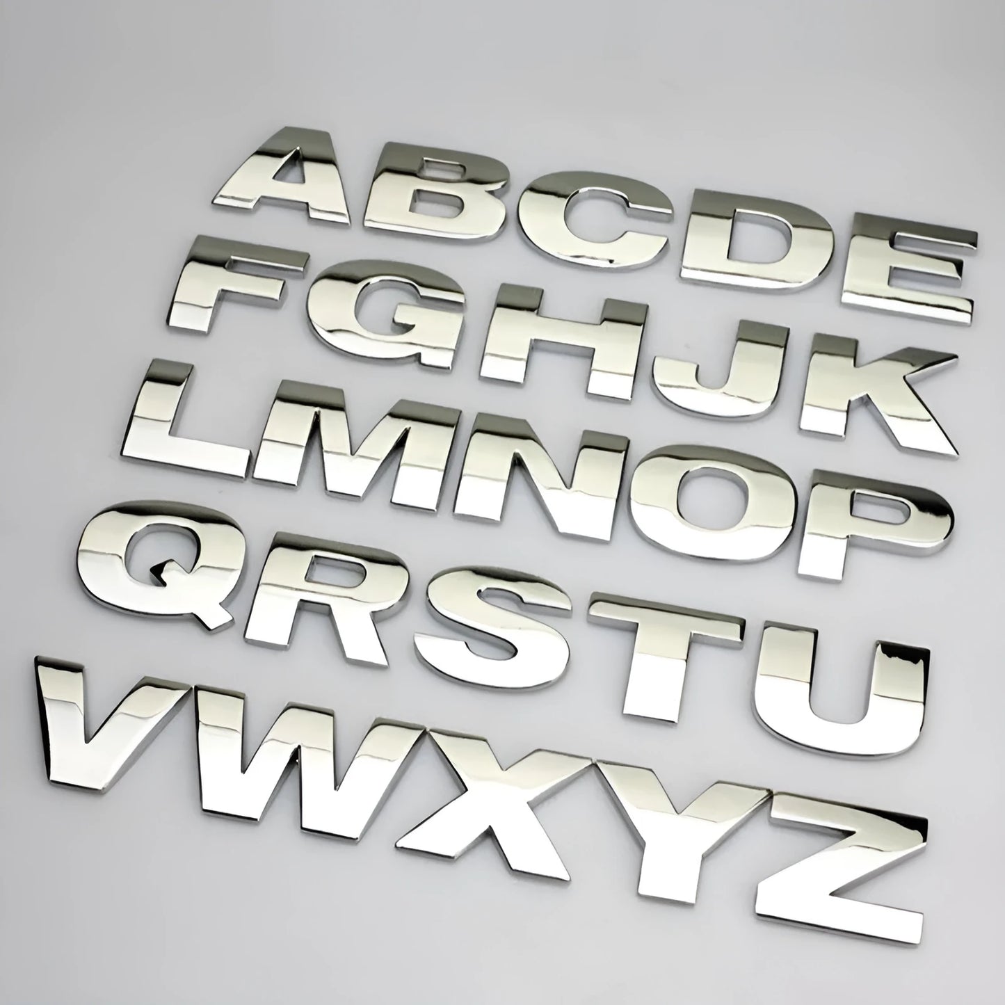 Metal zinc alloy car bumper sticker letters showing 3D design in black and silver finishes