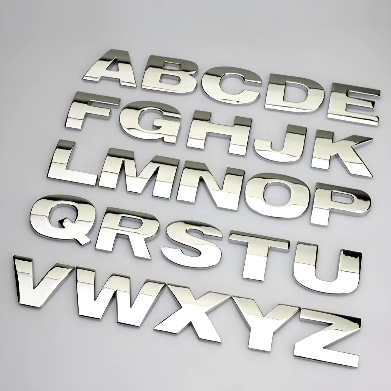 Metal zinc alloy car bumper sticker letters showing 3D design in black and silver finishes