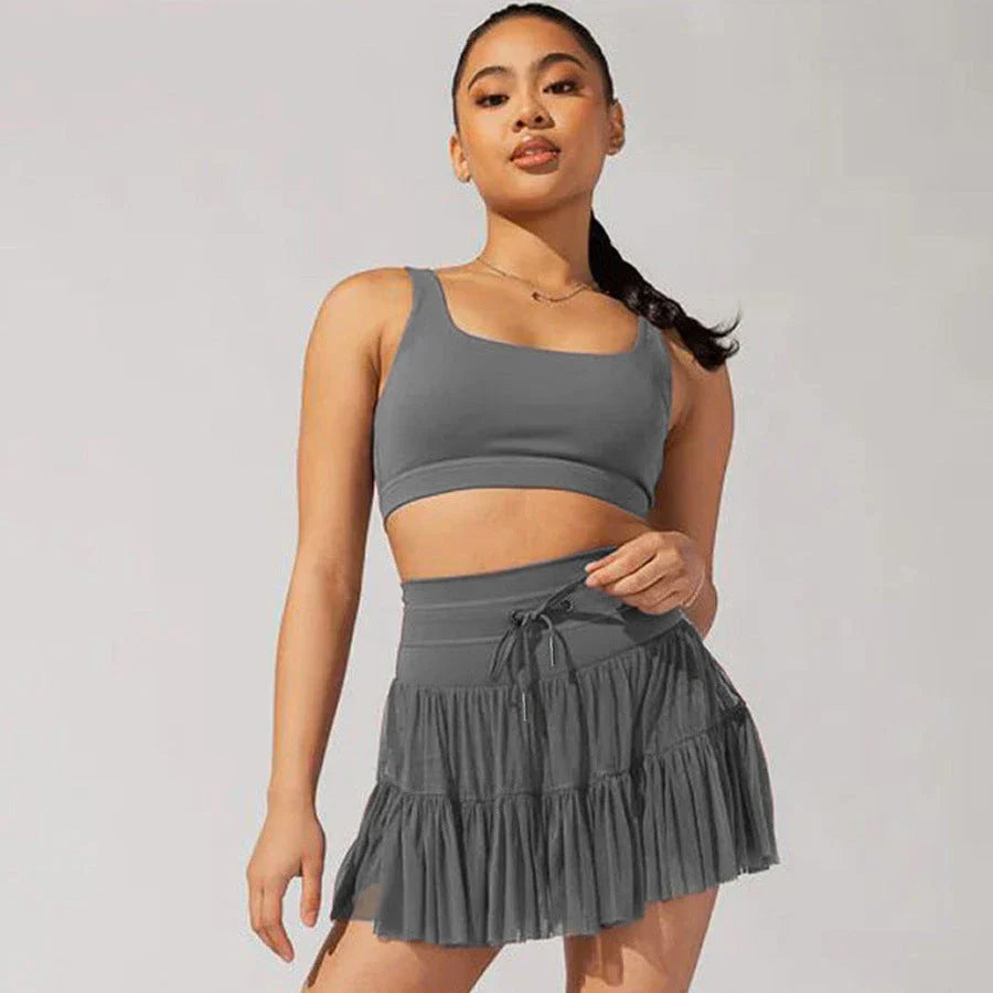 Stylish high-waist pleated skirt with lace-up accents in various colors, including black, gray, blue, apricot, pink, white, and purple