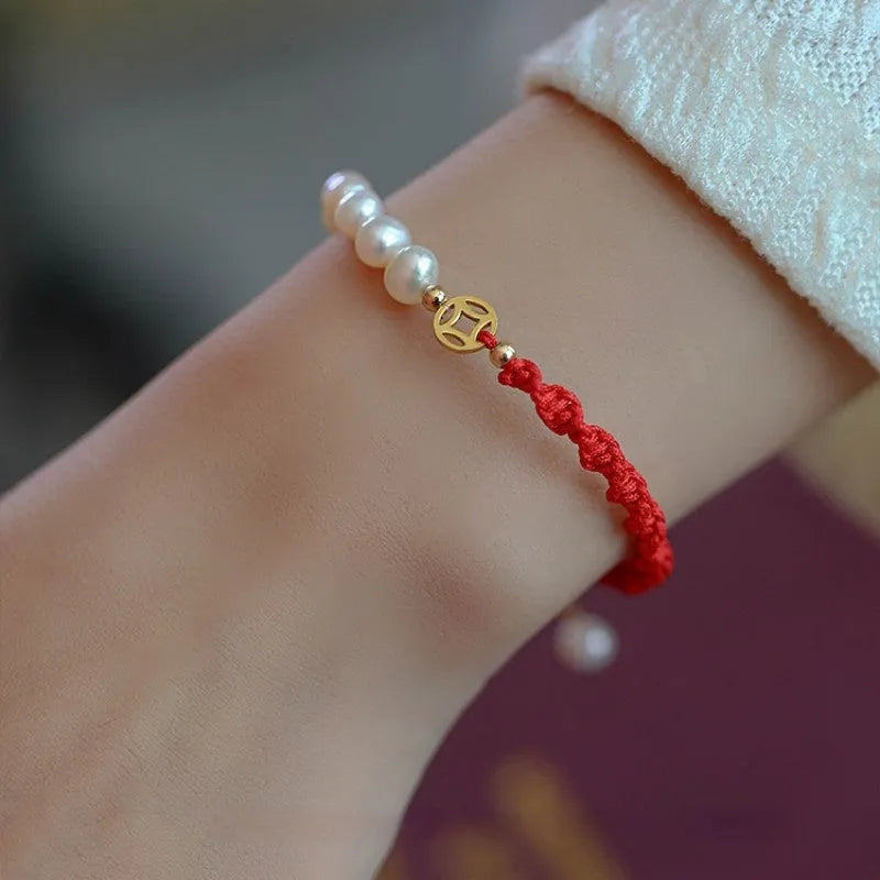 Women's pearl bracelet with braided red rope and geometric fu character charm