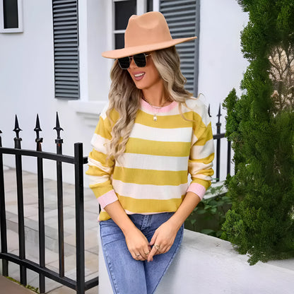 Women's loose blue striped acrylic sweater with long sleeves and round neck.