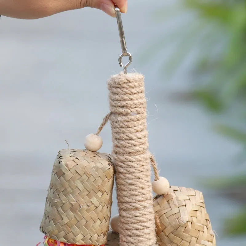 Natural wood and sisal rope shredded paper parrot activity toy measuring 15 by 35 centimetres.
