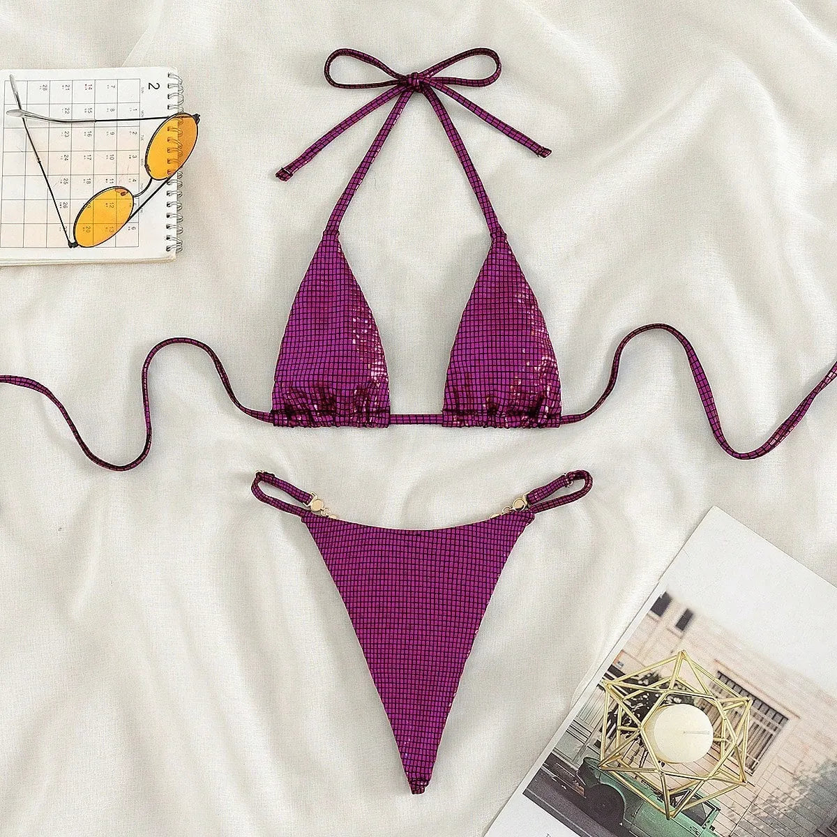 Women's solid colour blue T-back split bikini top and briefs set on a neutral background.