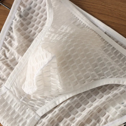 Men's low waist transparent lace underwear in various colours on a size chart background.