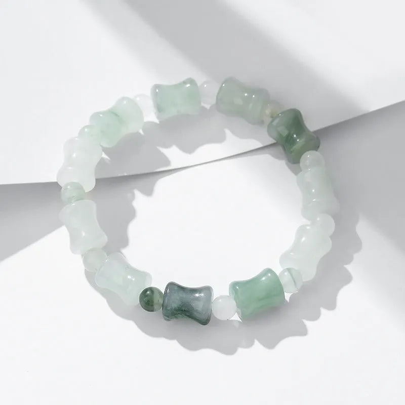 Simple Korean-style bracelet with natural chalcedony and coconut shell beads on an elastic string, showing the diamond-shaped safety lock.