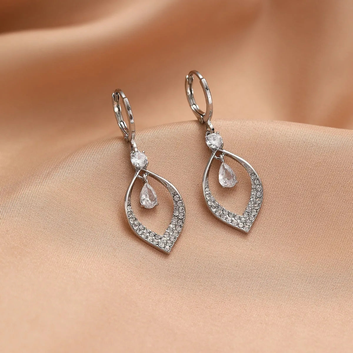 Women's copper teardrop tassel earrings with zircon detail and choice of gold or silver buckle.