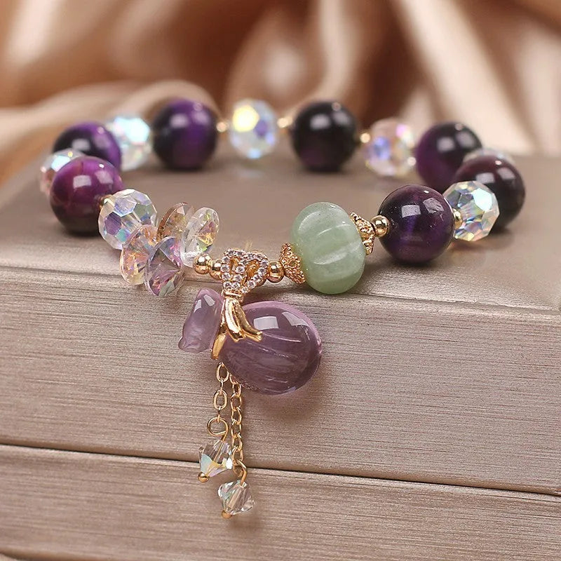 Women's crystal bracelet with purple tigereye money bag pendant and rhinestone decorations