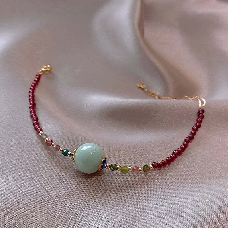 Women's garnet bracelet with aquamarine tourmaline drop charm and electroplated finish