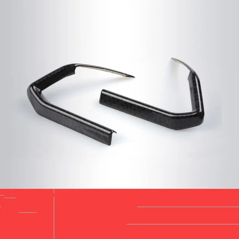 Carbon fibre patterned left and right steering wheel frame overlays for car interior upgrade.