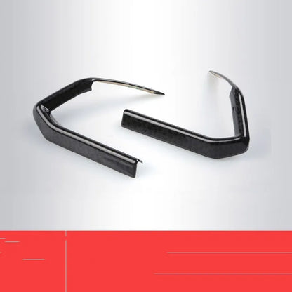 Carbon fibre patterned left and right steering wheel frame overlays for car interior upgrade.