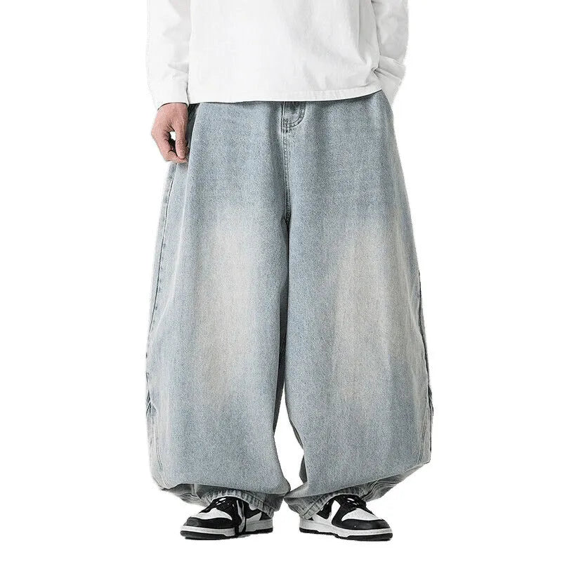 Men's plus-size light blue wide-leg baggy jeans on a neutral background.