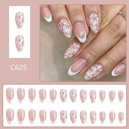 Short glossy almond false nails with glittering powder flower designs in C625 colour