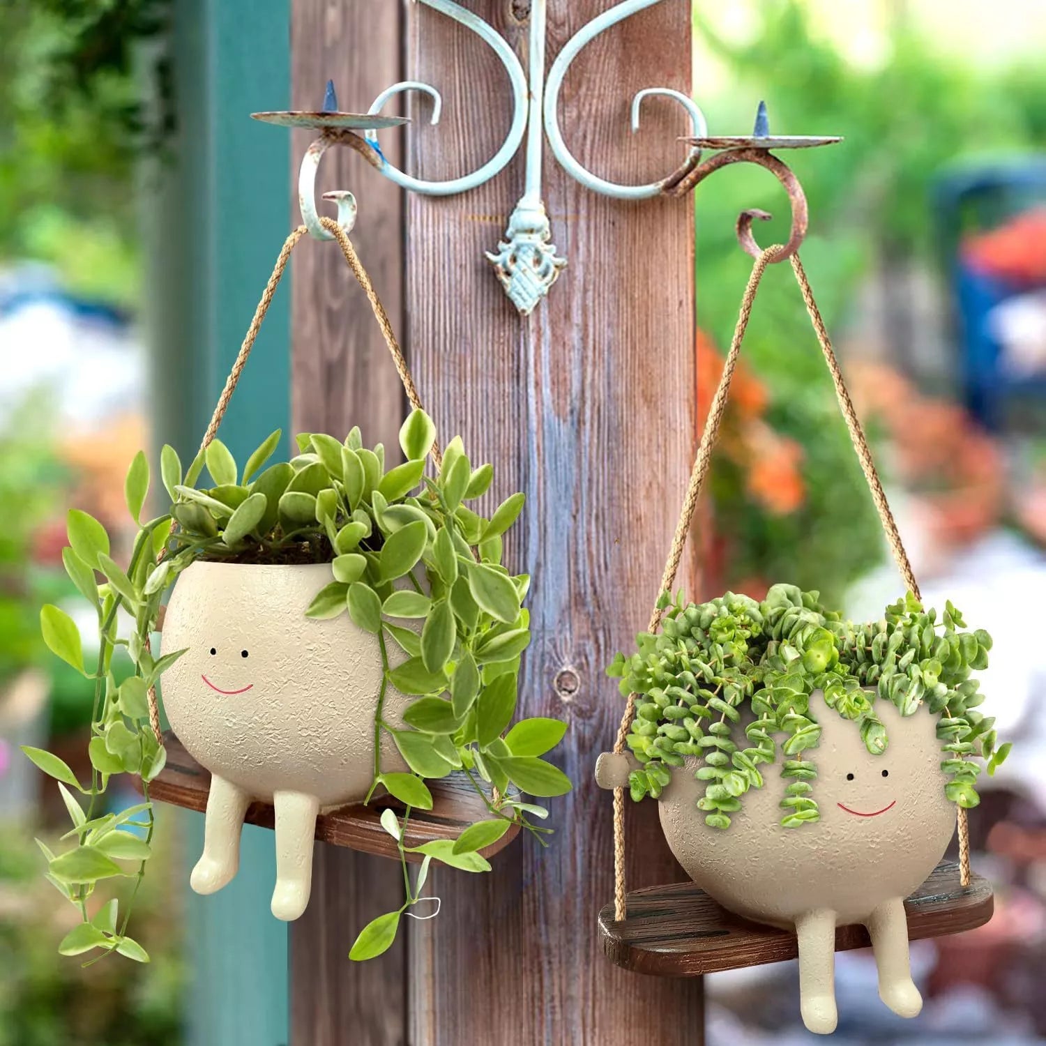 Swing face hanging flower pot with child's smiling design, made of durable resin