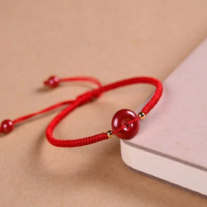 Cinnabar heart-shaped bracelet with safety buckle closure and adjustable coloured rope in traditional Chinese design