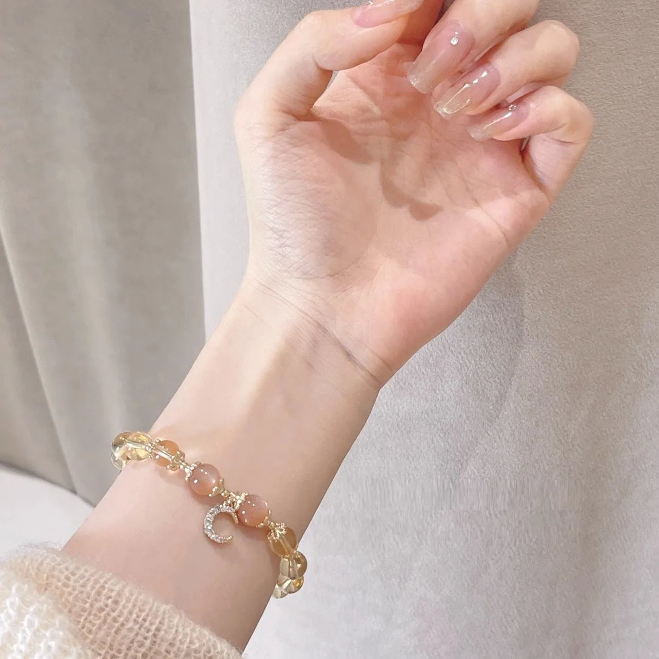 Women's gold electroplated crystal bracelet with moonstone and sunstone stones in Chinese style design.