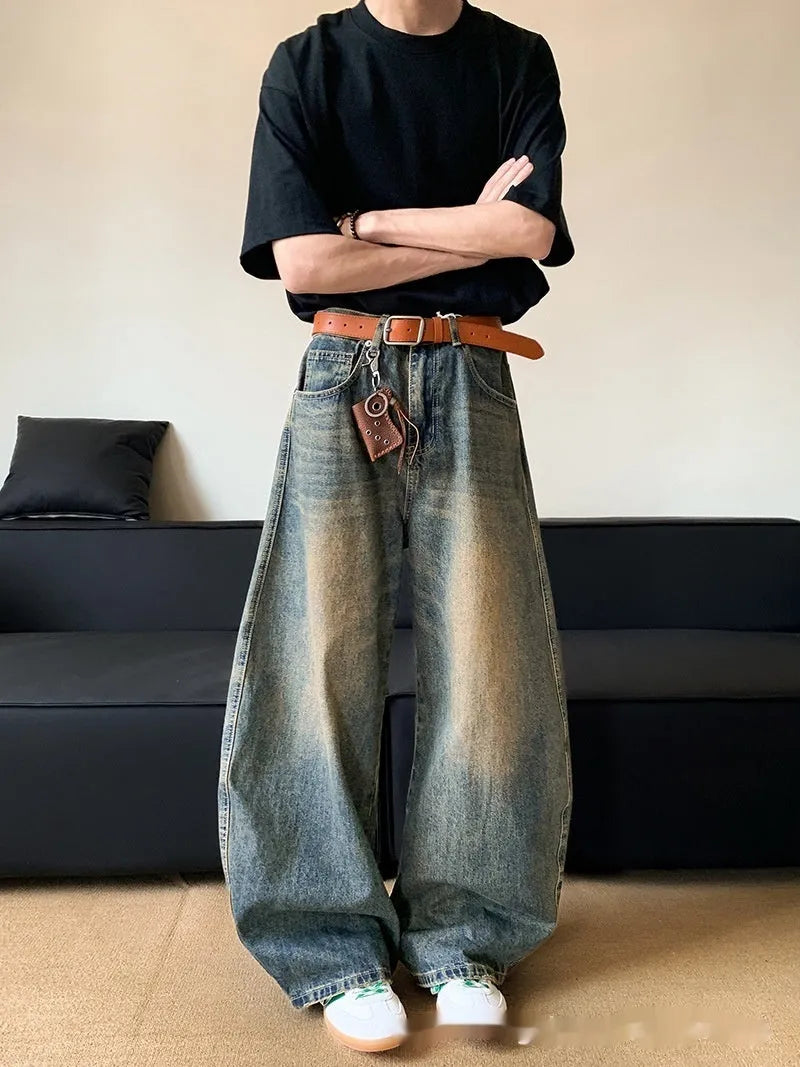 Men's distressed retro blue jeans with a slim wide-leg cut and mid waist.