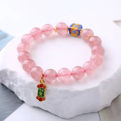 Pink crystal bracelet with Strawberry Quartz stones and Ruyi charm in hand-woven women's jewellery design