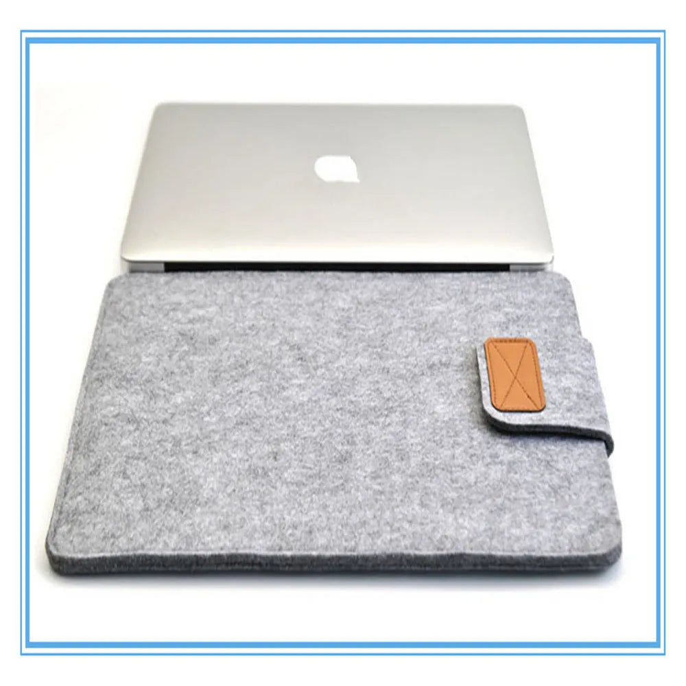 Dark grey clamshell laptop bag open to show plush internal liner and corner protectors.