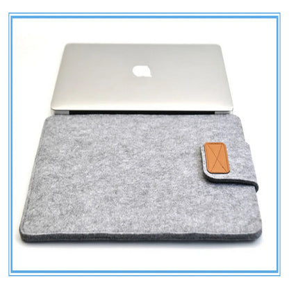 Dark grey clamshell laptop bag open to show plush internal liner and corner protectors.