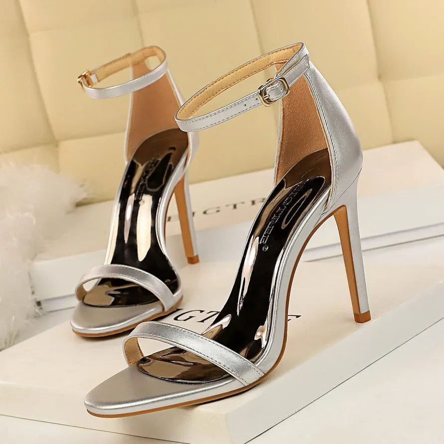 Women's open-toe high heels with an ankle strap and buckle, shown in multiple colours.