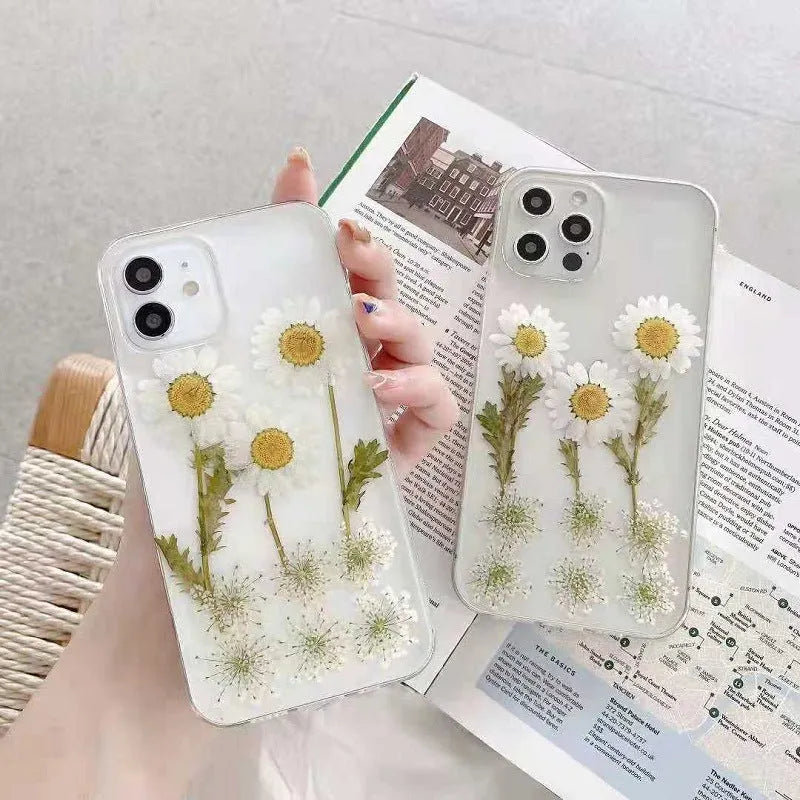 White iPhone case with a raised epoxy daisy flower pattern on the back.