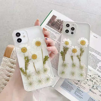 White iPhone case with a raised epoxy daisy flower pattern on the back.