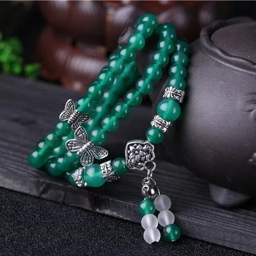 Close-up of a green agate multi-layer chain bracelet with three strands of 6mm beads.