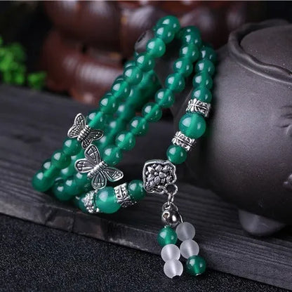 Close-up of a green agate multi-layer chain bracelet with three strands of 6mm beads.