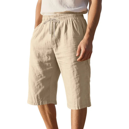Men's loose-fit linen shorts in a solid colour with a drawstring waist and cropped leg length.