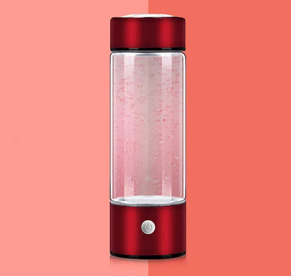 Portable hydrogen water bottle with glass chamber and stainless steel components showing electrolysis bubbles