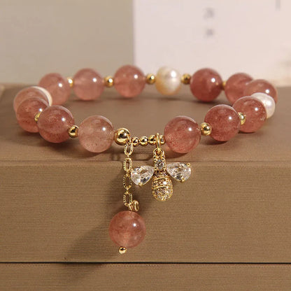 Women's adjustable bracelet with freshwater pearls, strawberry quartz stones, and bee charm