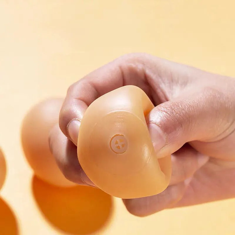 Durable rubber dog chew toy shaped like an egg with sound simulation for puppy teeth cleaning
