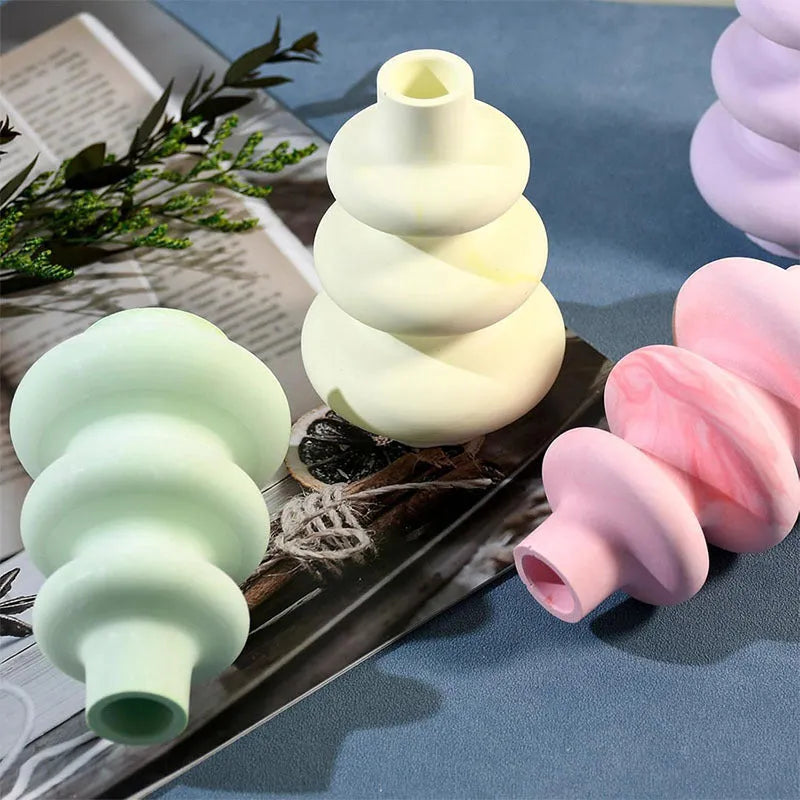 Silicone baking mould in shape of three-layer irregular circle vase on white background