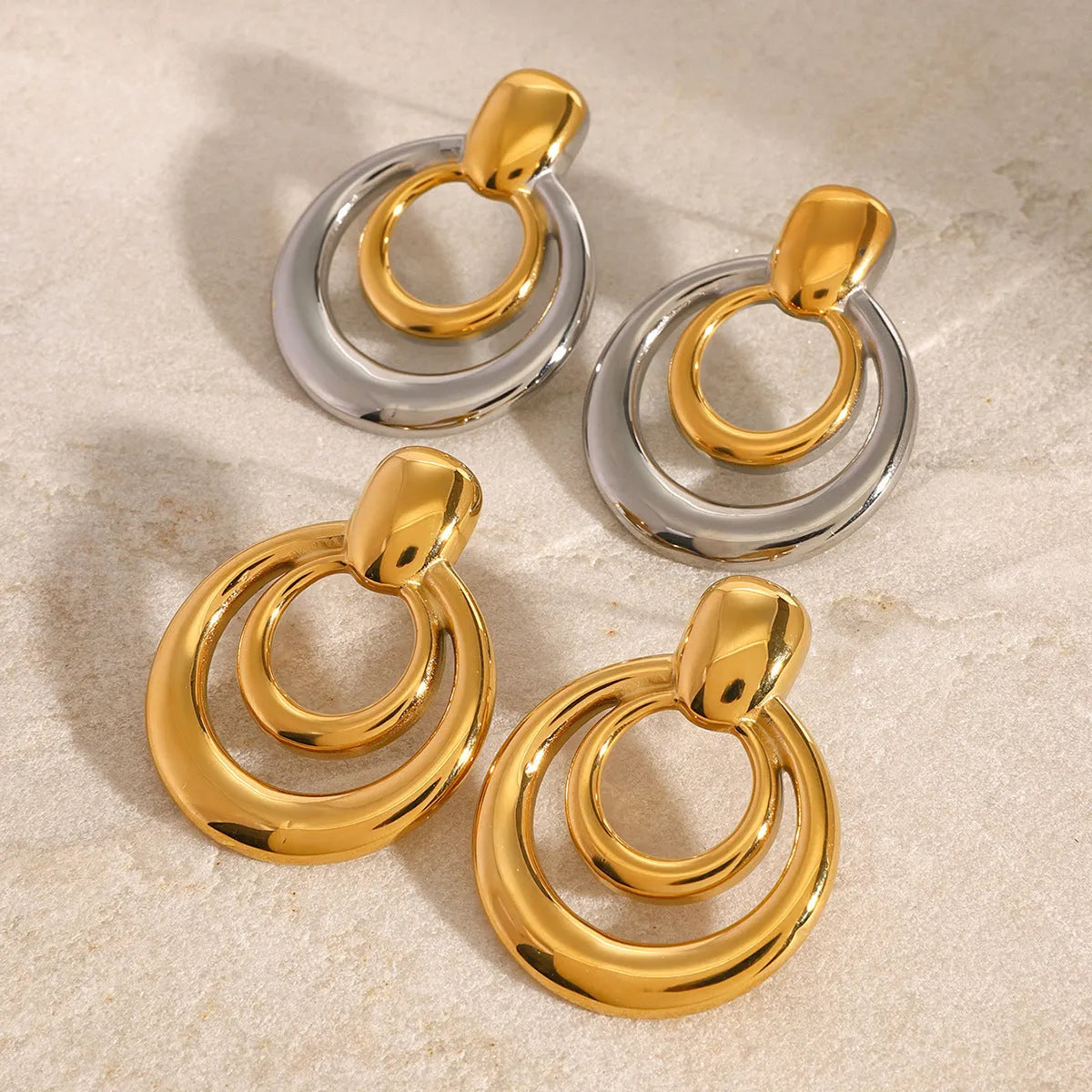 Round double layer hollow stud earrings with 18K gold electroplating on titanium steel, 12mm diameter