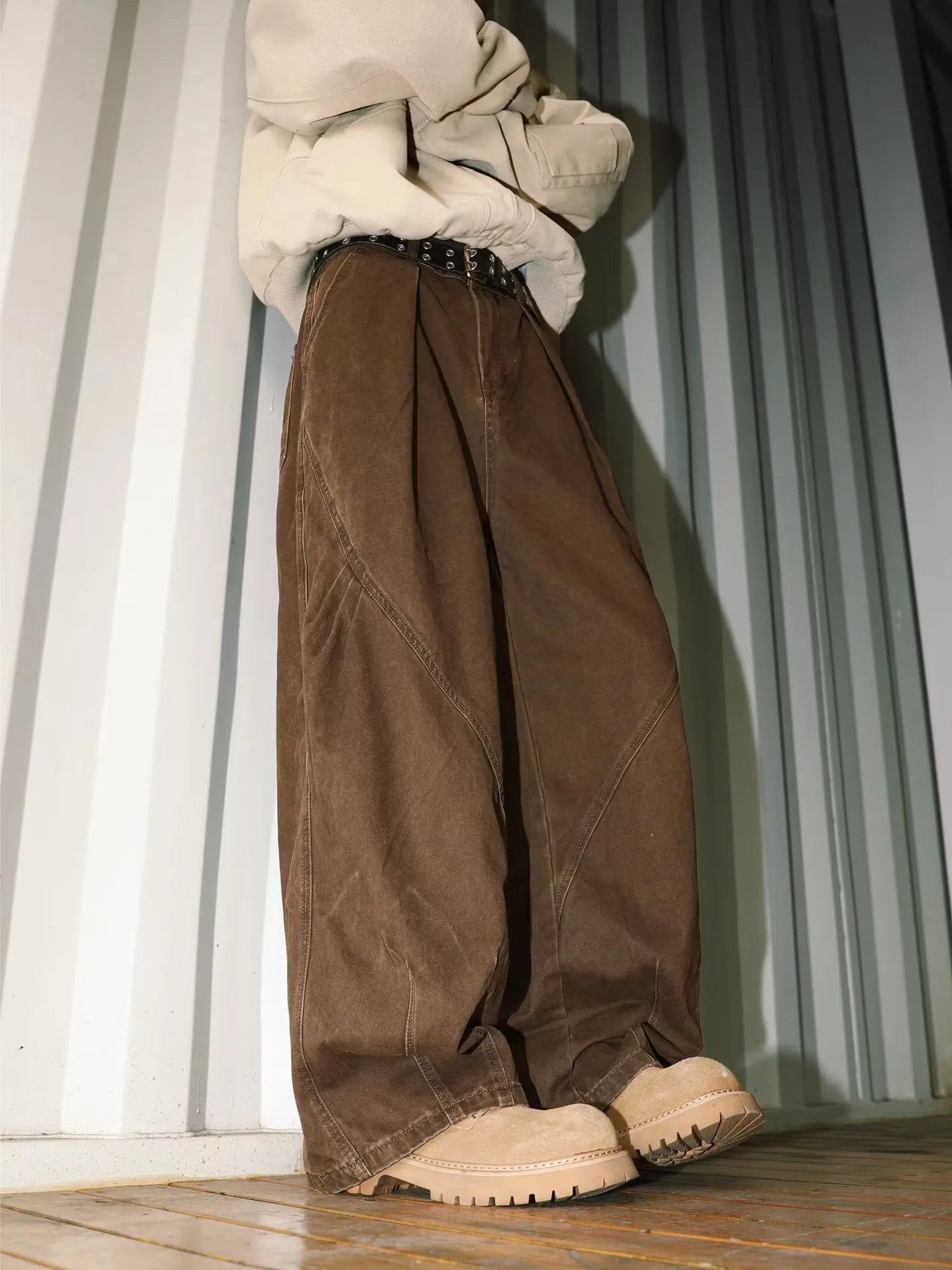 Man wearing pleated straight-leg trousers in a striped pattern with a micro elastic mid waist.