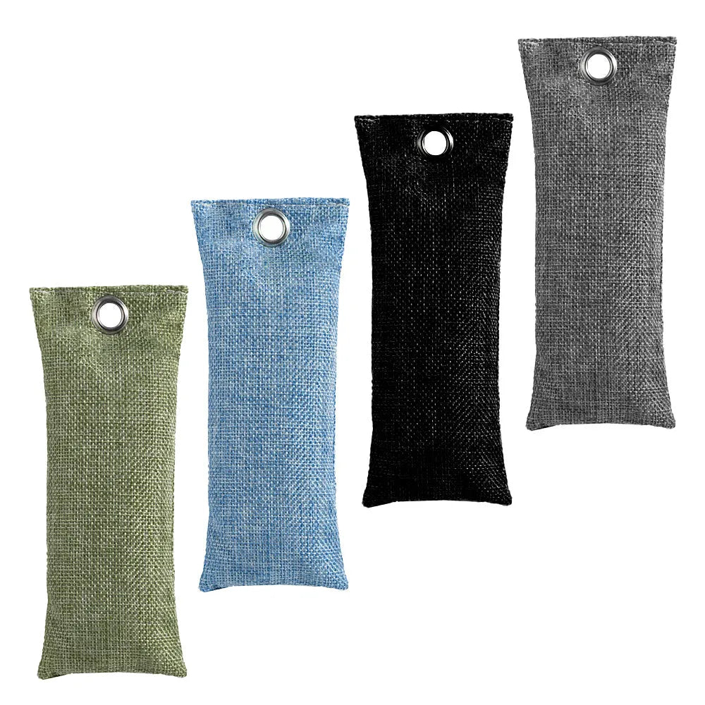 Set of black, green, grey, and blue rectangular bamboo charcoal deodorising bags on a white surface.