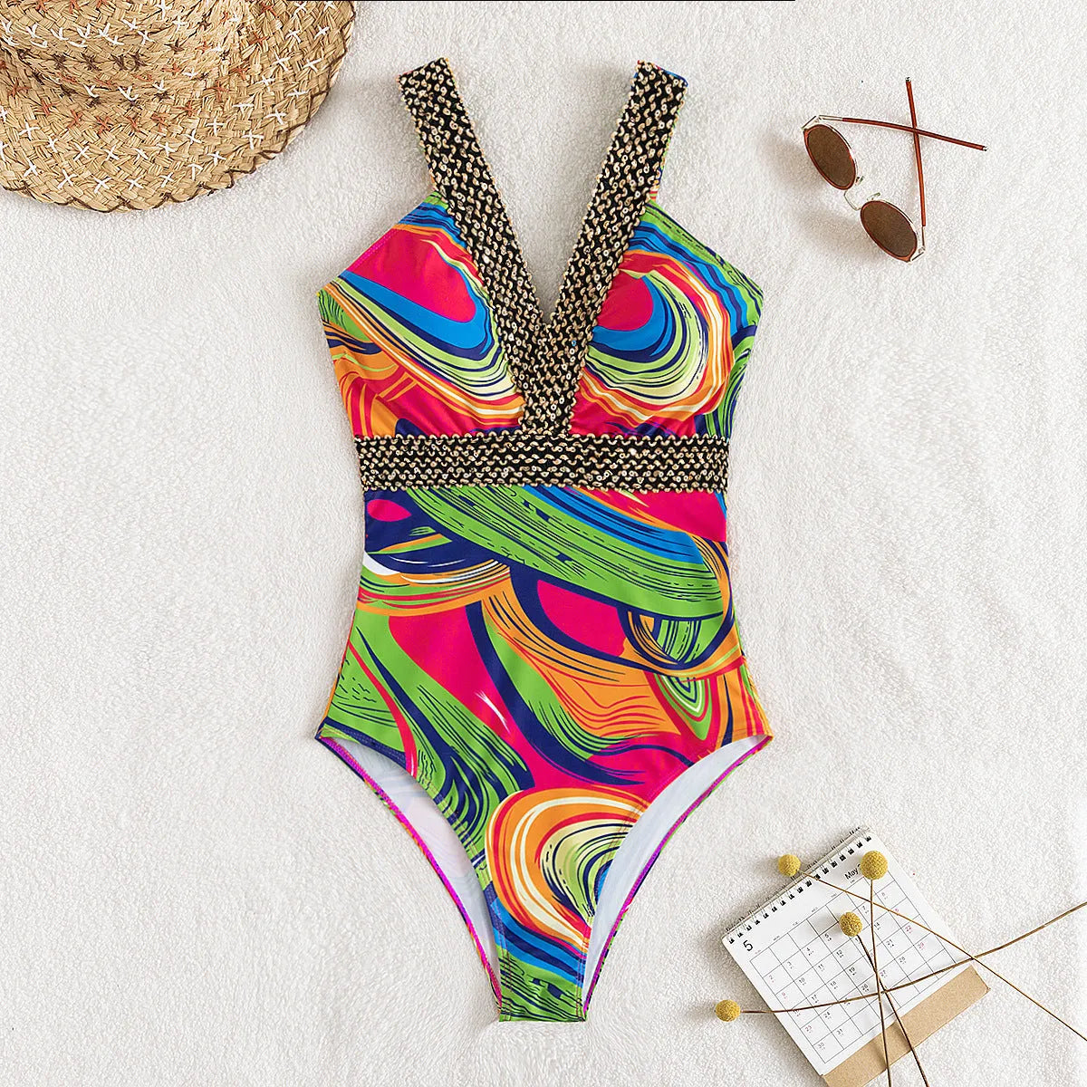 Women's deep V neck one-piece swimsuit with spaghetti straps in printed polyester fabric.