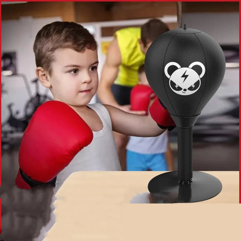 Tabletop boxing speed ball with suction cup base on a desk, showing burst bear design and flexible connection tube