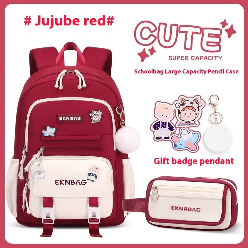 Pink waterproof school backpack for girls with curved ergonomic shoulder straps, shown with matching pencil case.