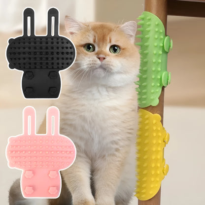 Silicone cat grooming comb with adjustable strap mounted on a table leg, shown in green.