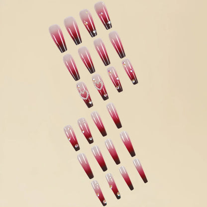 Set of long false nail tips with wine red gradient colour, plaid pattern, and a pearl heart design.