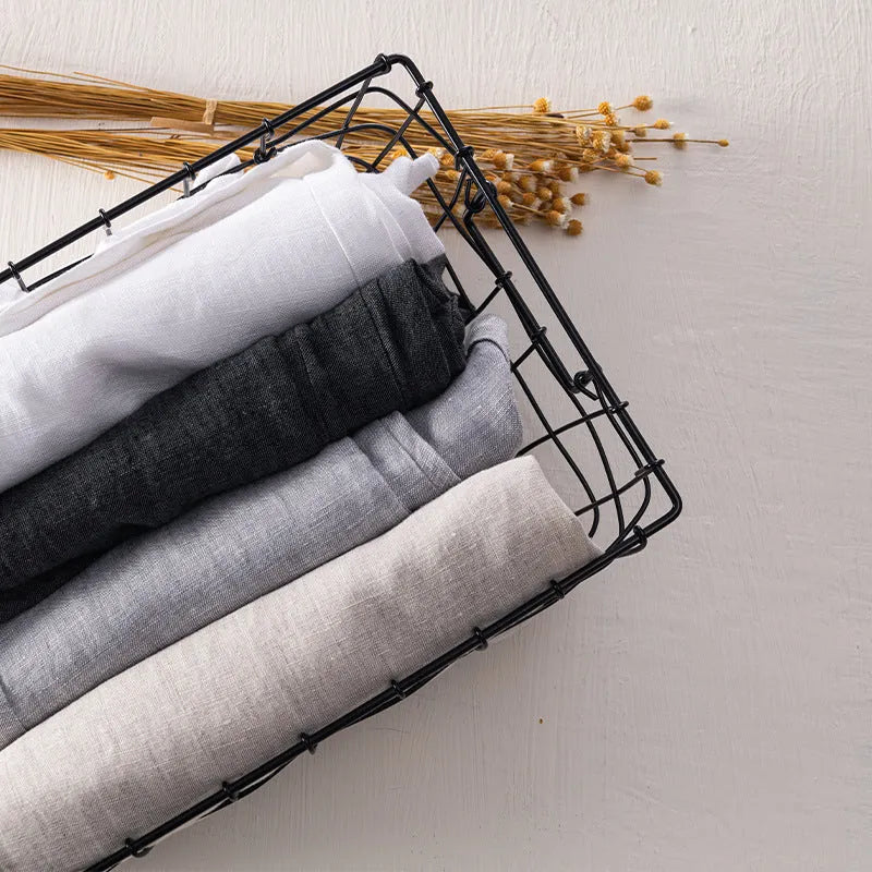 Men's straight linen trousers in four colour options showing mid waist and straight-leg cut